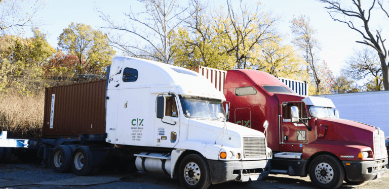 Two trucks with the Canaan Xpress logo on them.